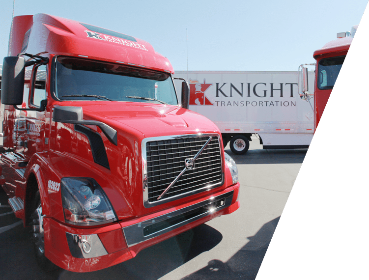 Knight Transportation cabs in front of company trailer