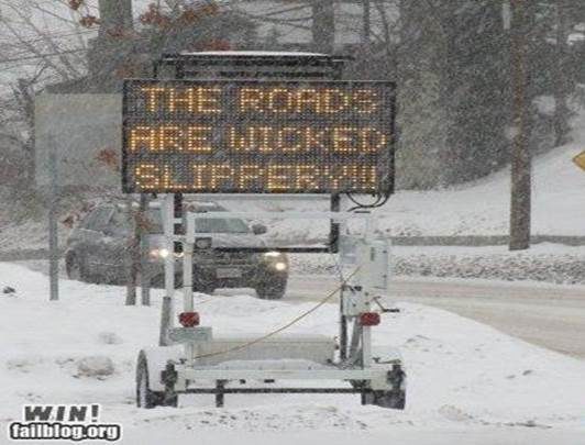 Road sign in winter reads "The Roads Are Wicked Slippery"  Top 10 Truck Driving Tips for Winter